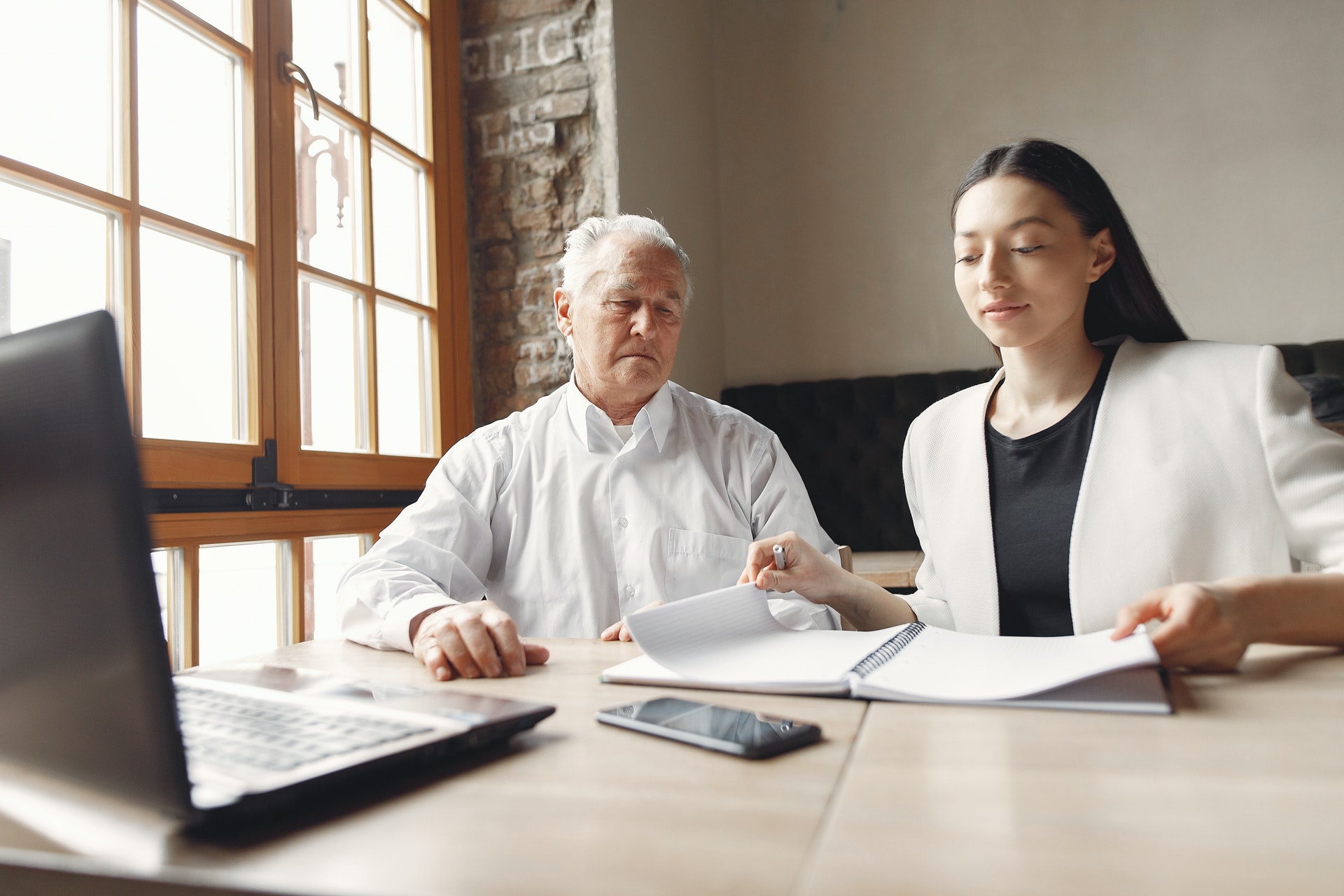 older man going through paperwork with woman